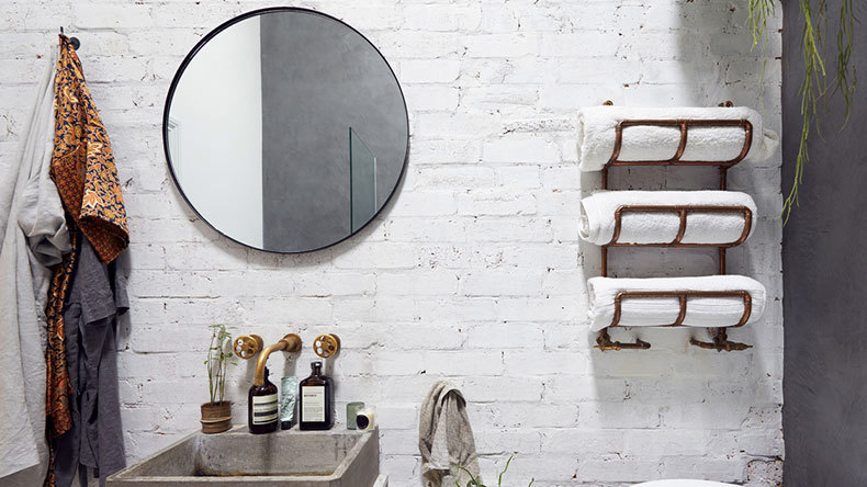 industrial bathroom with copper towel rack